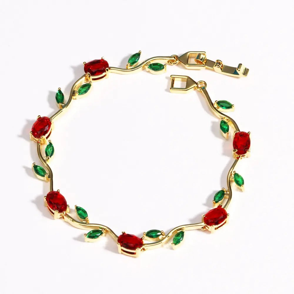 Gold Tulip b bracelet with red and green gemstones on a white background sasha jewels 